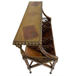 Early 20th century Chippendale design mahogany booktrough, top-tier with gadrooned edge, the trough fitted with trapezoid fretwork dividers, raised on ring turned supports united by X-stretcher 