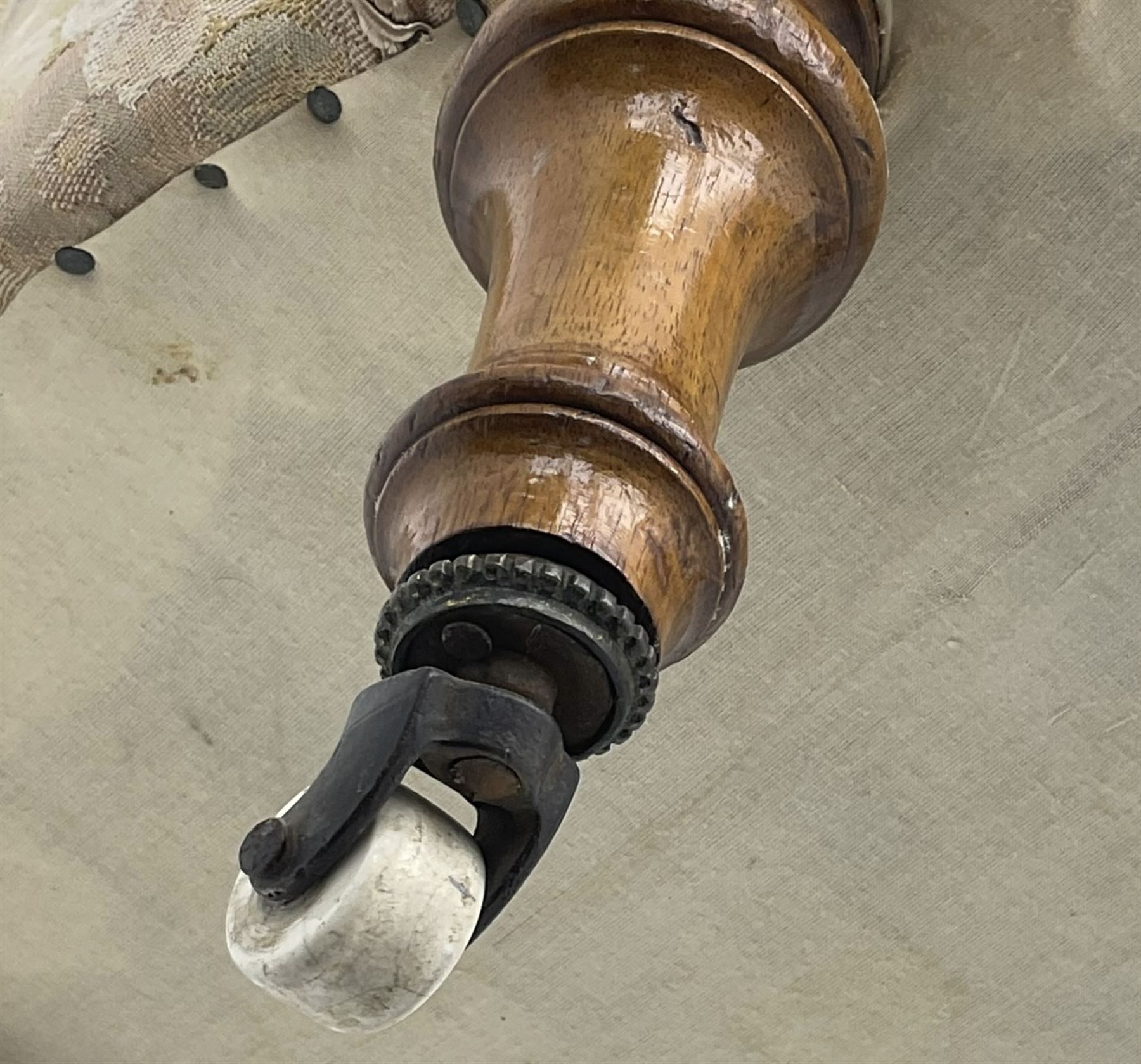 Victorian walnut framed nursing chair, upholstered in buttoned floral pattern fabric, on turned front feet 