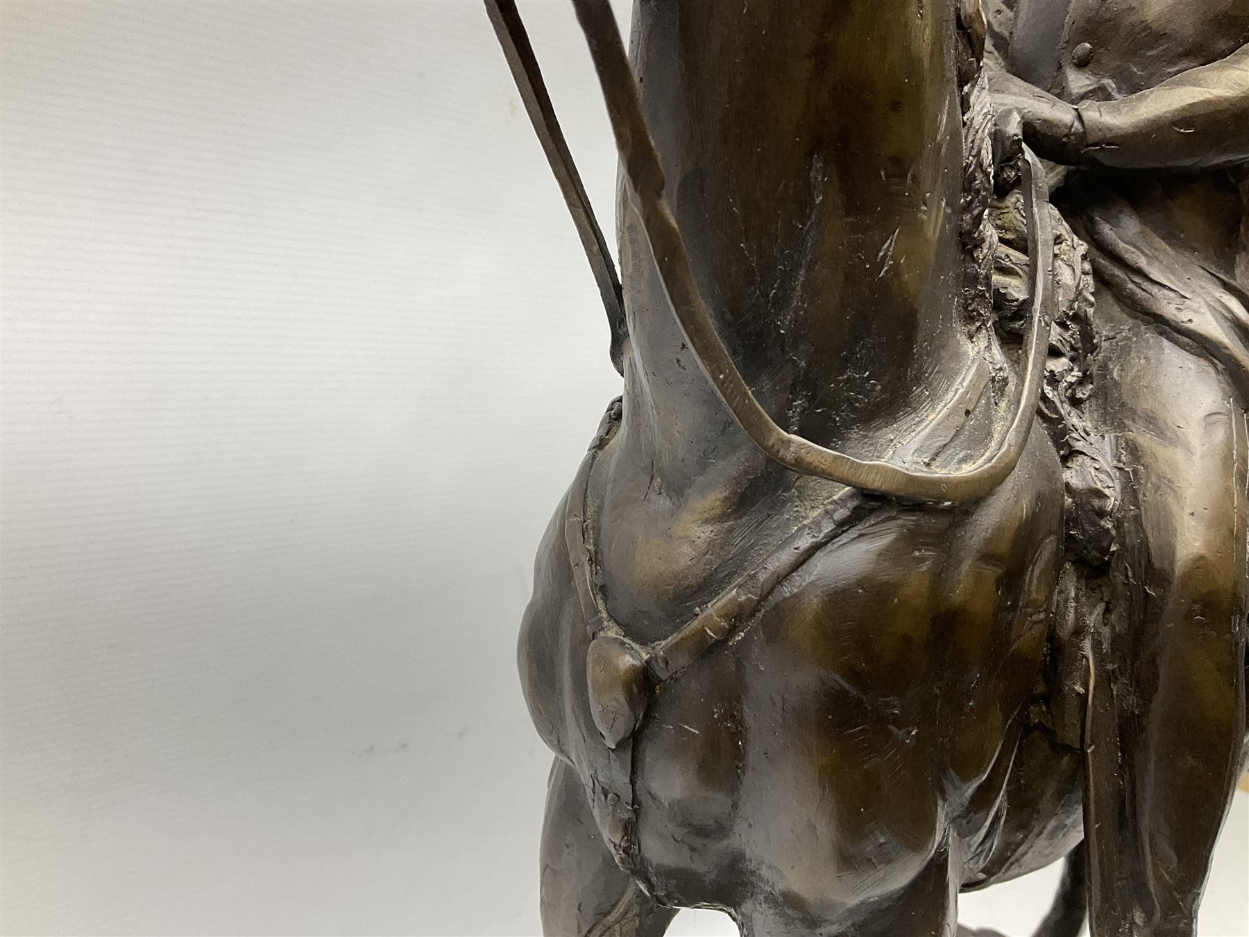 Large and impressive bronze figure of Wellington seated on a horse, on a sarcophogus shaped stepped base impressed 'Meunier Paris', the canted corners inset with battle trophies H68cm L50cm D22cm