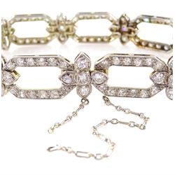 18ct white gold and platinum, milgrain set old cut diamond flower head and openwork panel link bracelet, total diamond weight approx 4.25 carat