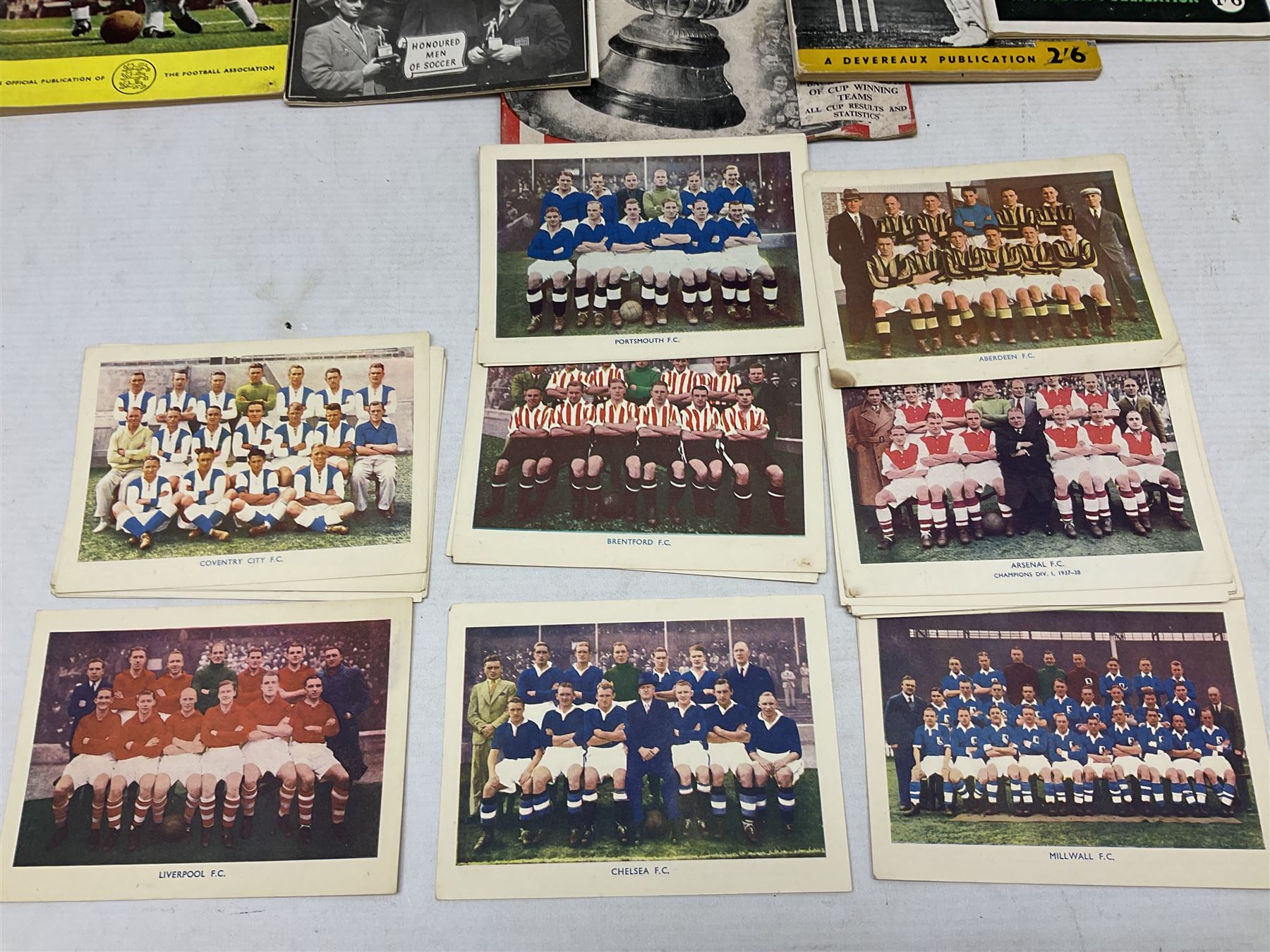 Football - Sherman's Searchlight on Famous Teams trade cards 1938-39 (28) and Searchlight on Famous Players (15); and nine booklets including F.A. Cup Annual 1951;two early 1960s F.A. Yearbooks etc; together with seven photographs of cricket teams, first half of 20th century; and four 1940s and later cricket booklets; and a signed postcard of boxer Len Harvey