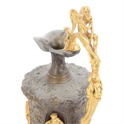 Pair of bronzed and gilt ewers in the Neo-Classical taste, each of typical form with figural detailed and mounted scroll handle surmounted by a winged figure, the bodies cast with scrolling strapwork, flower heads and acanthus leaves, and further detailed with applied gilt classical figures to oval recesses, upon a knopped stem and spreading circular foot with conforming cast detail, H28cm