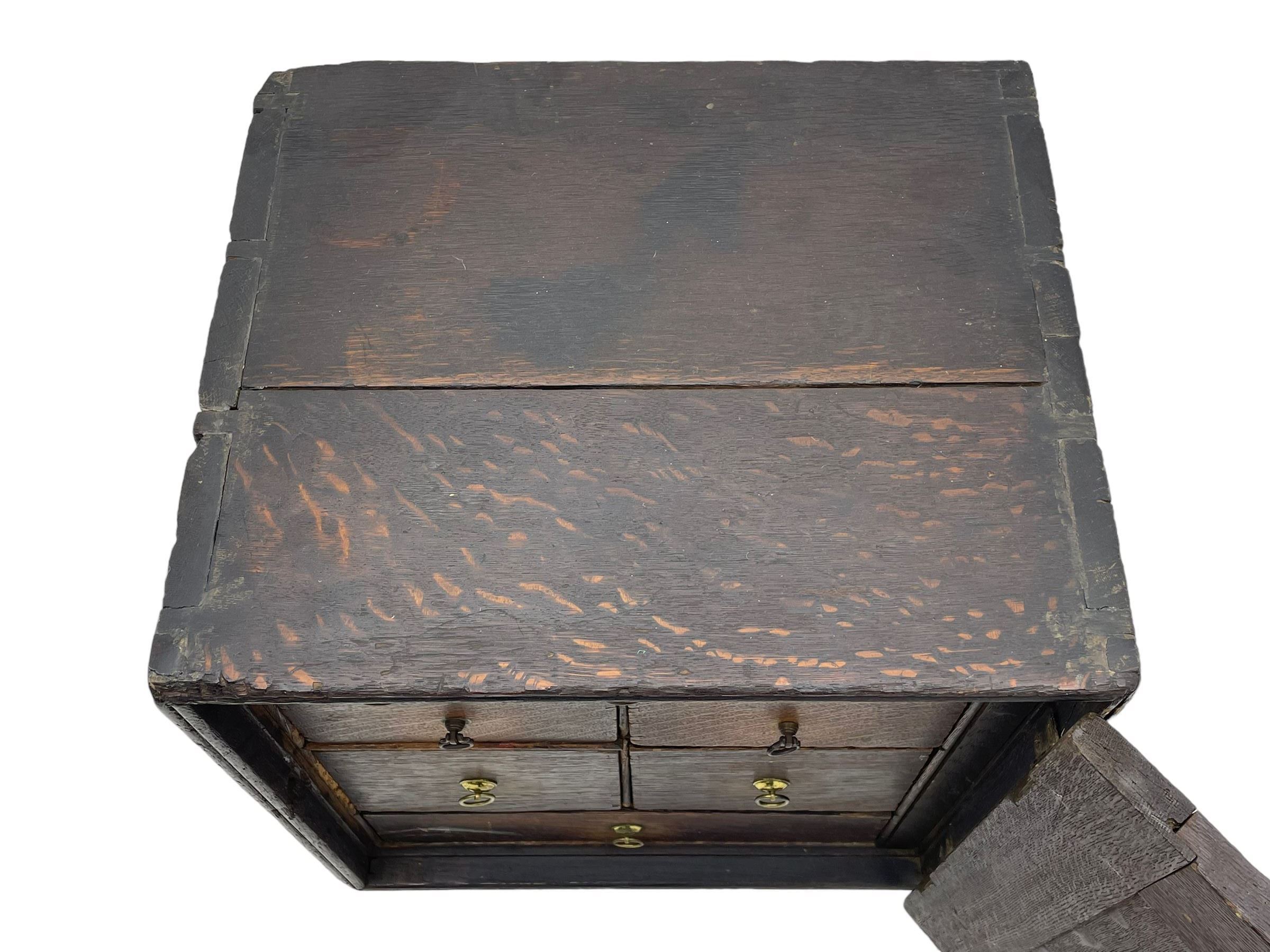 18th century oak spice cupboard, single panelled door enclosing eight drawers of various sizes, reed moulded front edges