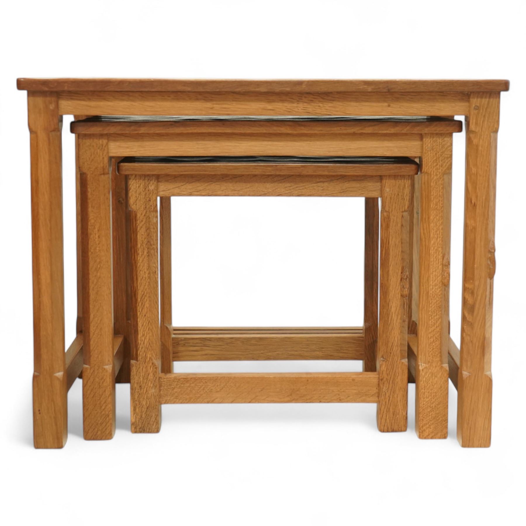 Mouseman - nest of three oak occasional tables, rectangular adzed top, on octagonal supports united by plain stretchers, each carved with mouse signature, by the workshop of Robert Thompson, Kilburn 