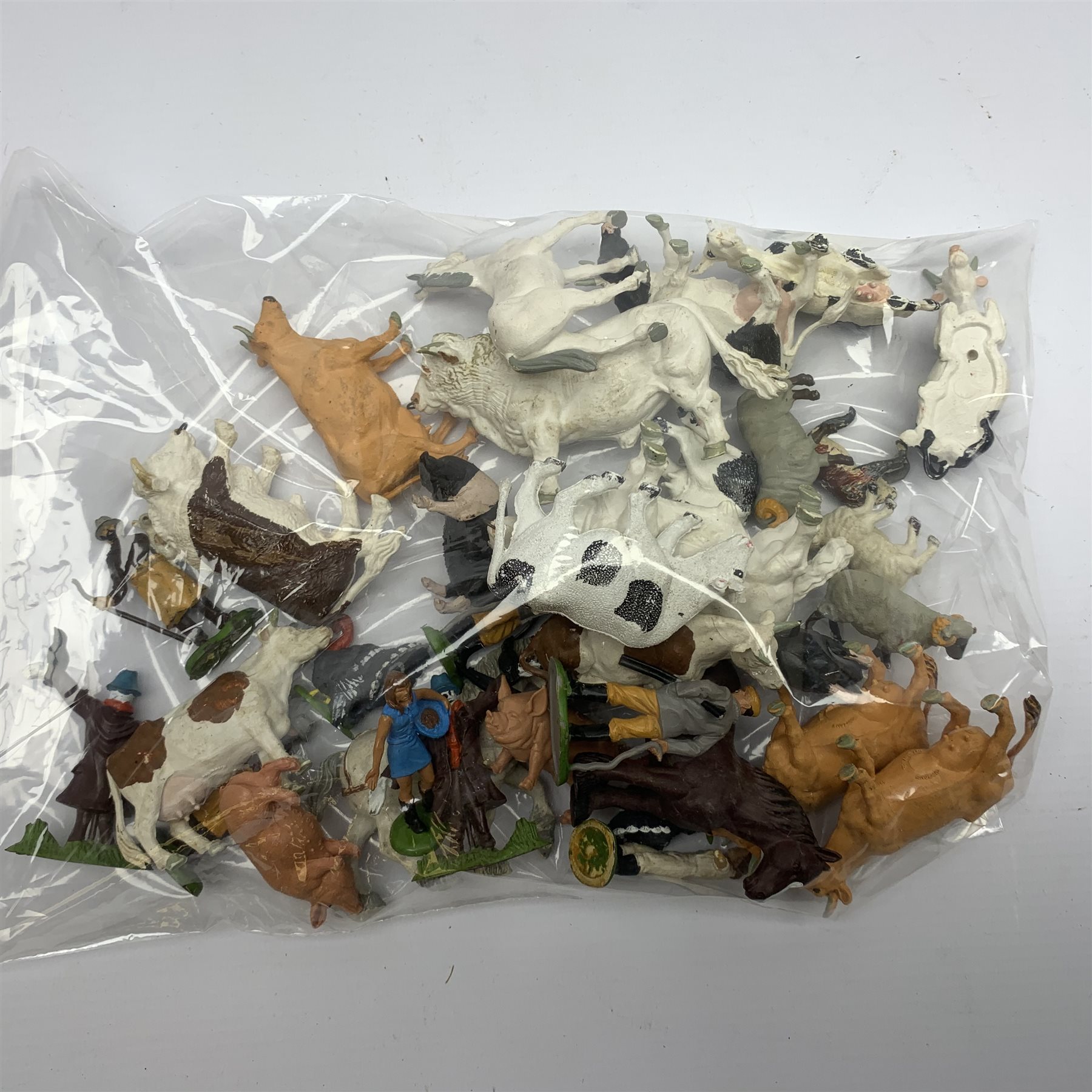 Farmyard layout including large walled wooden base board 61 x 45cm with various wooden buildings and plastic accessories, die-cast tractors and farm machinery by Britains, Ertl etc, plastic farm animals and figures by Britains etc