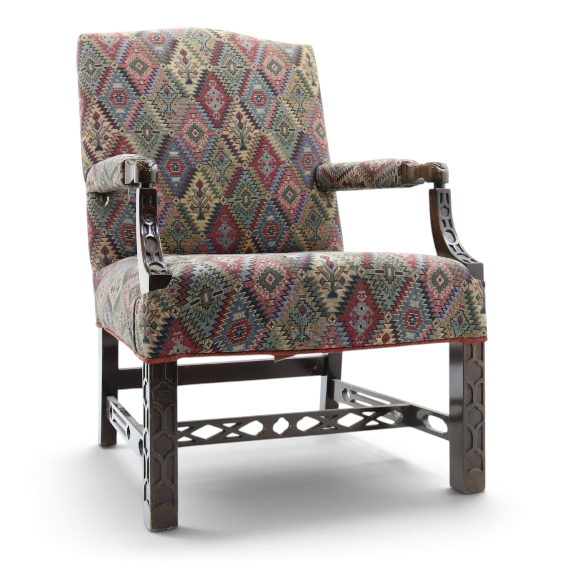 Chippendale design Gainsborough elbow chair, upholstered in kilim fabric, blind fretwork and acanthus carving