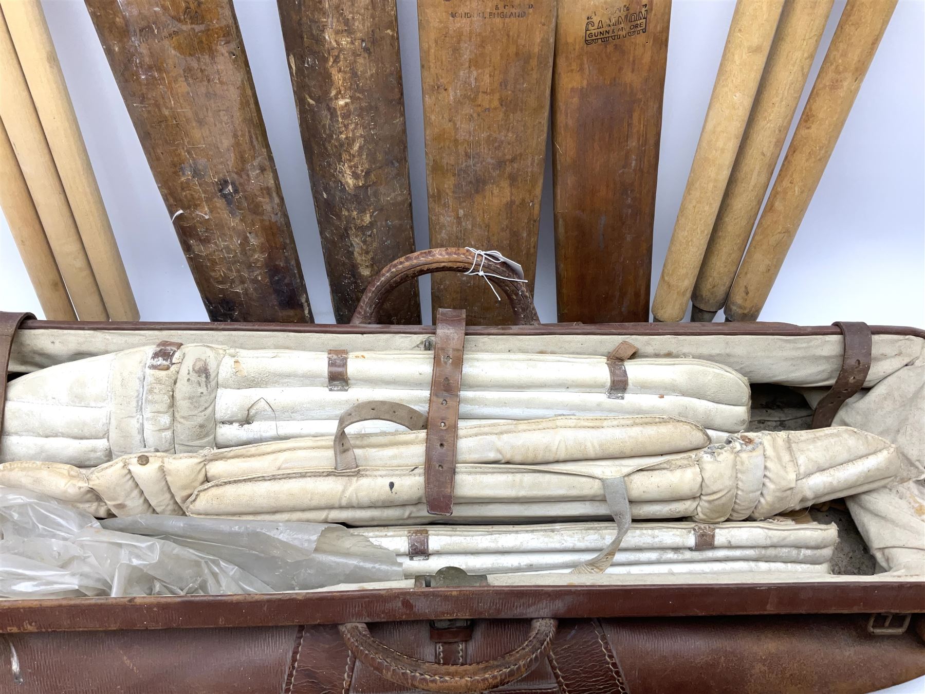 A Vintage leather cricket bag and equipment, to include cricket bats, balls, wickets, and pads. 