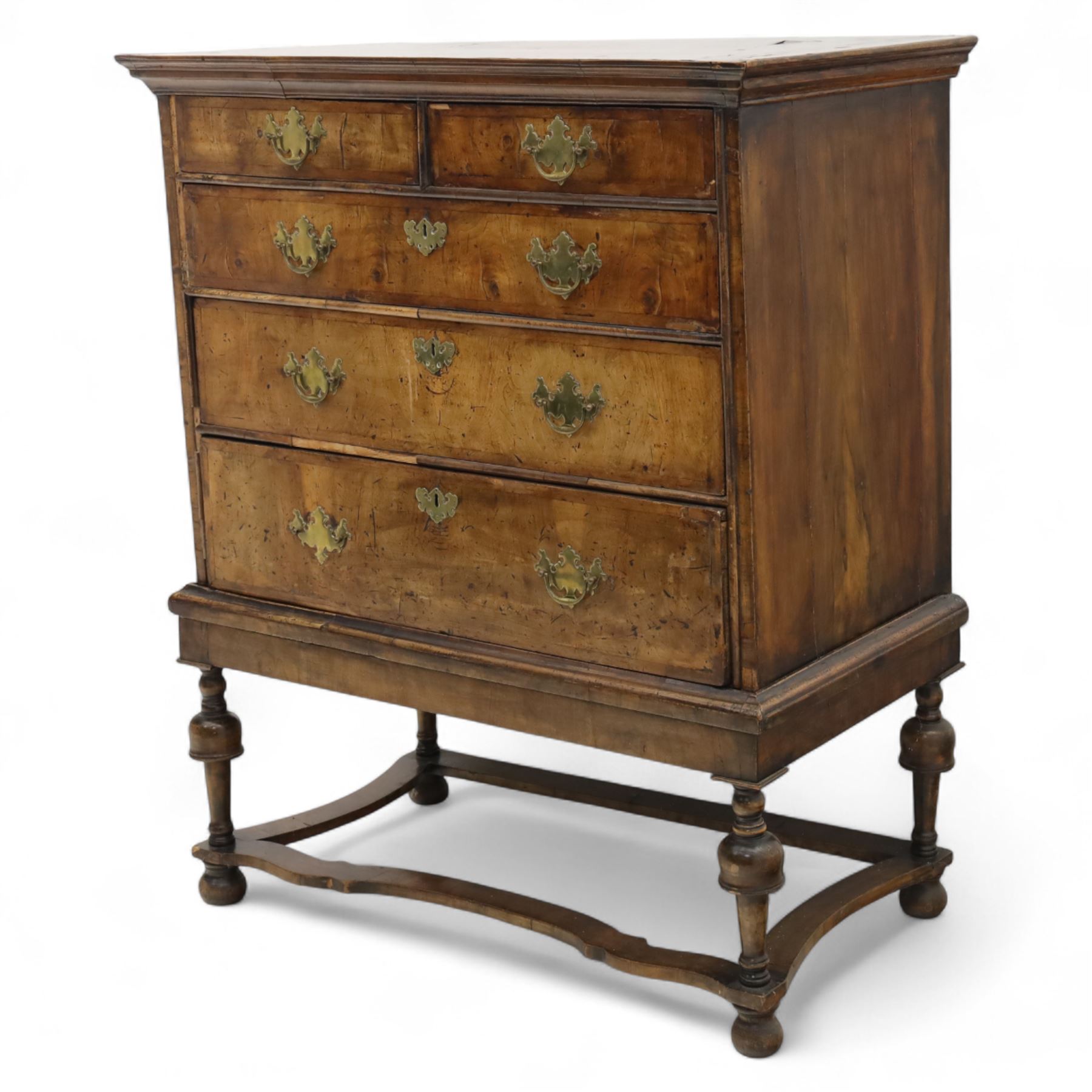 Early 18th-century burr walnut Queen Anne chest on stand, moulded rectangular top above two short and three long feather crossbanded drawers fitted with brass handles and escutcheons, on a later baluster turned stand with shaped stretcher 