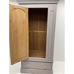 Painted pine single wardrobe, projecting cornice, single cupboard door, flanked by carved detailing, above single long drawer, plinth support