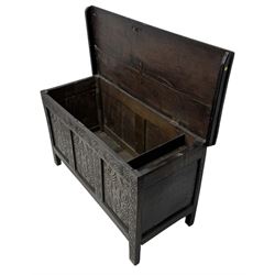 English carved oak coffer, hinged rectangular lid with indented side edges, internal candle-box, front with three-panel front with decorative carvings, raised on stile feet, circa 1700