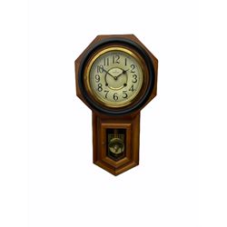 Contemporary spring driven wall clock striking the hours on a gong, case with a wooden octagonal dial surround and two piece creme dial with Arabic numerals, steel spade hands, brass effect pendulum bob visible through case door, dial inscribed 
