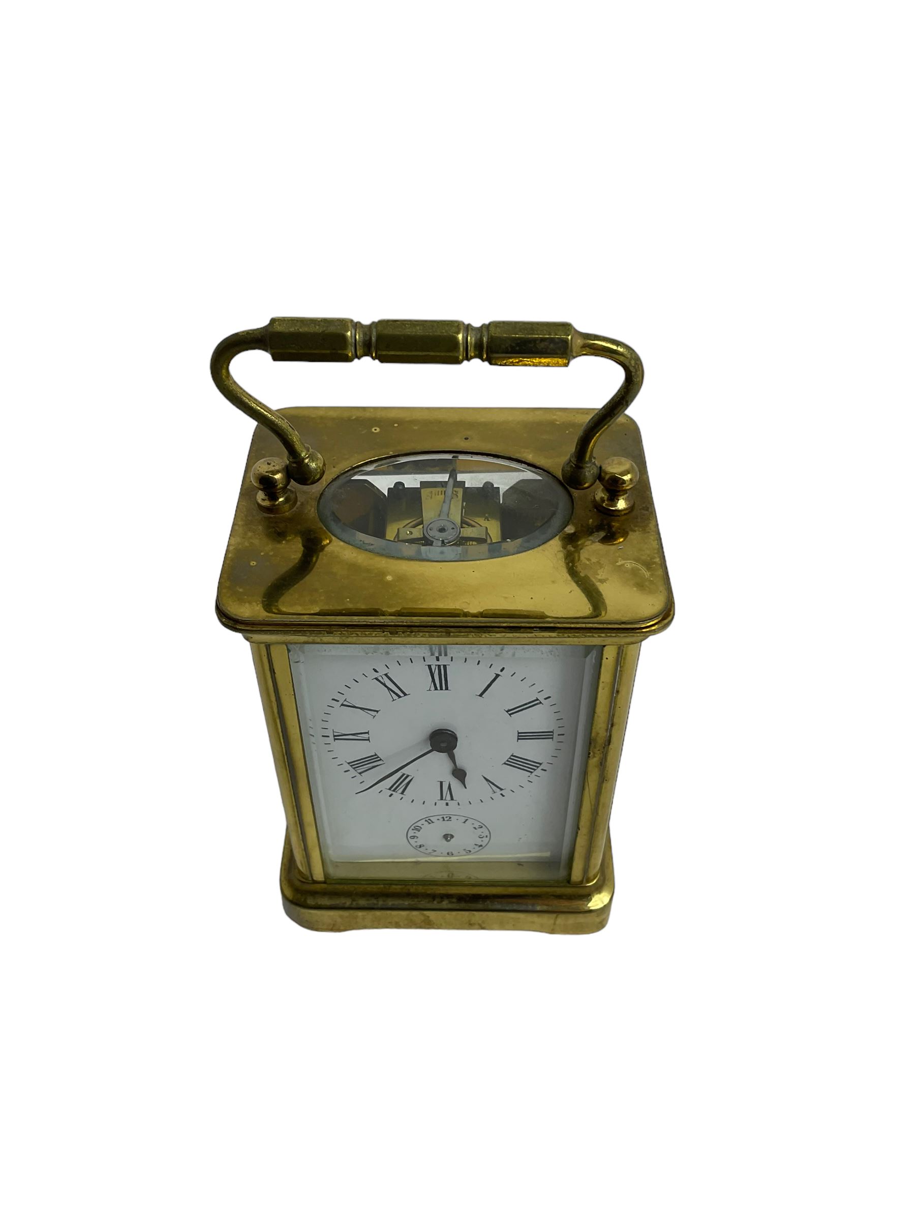 French - 19th century 8-day carriage clock with alarm, corniche case with an enamel dial, Roman numerals, minute markers and alarm setting disc, with a cylinder platform escapement, sounding the alarm on a bell. With key.