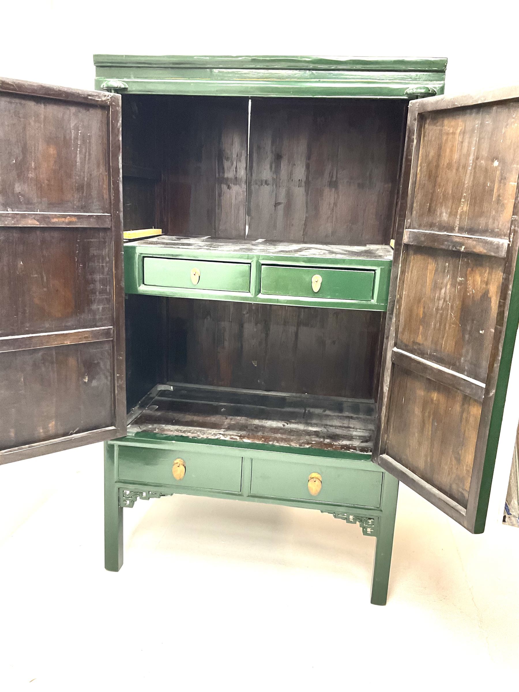 Chinese 'moon' rosewood raised cabinet, hammered brass centre piece featuring floral design, two cupboard doors enclosing two tiers and two short drawers, above two short drawers, shaped trim and stile supports 