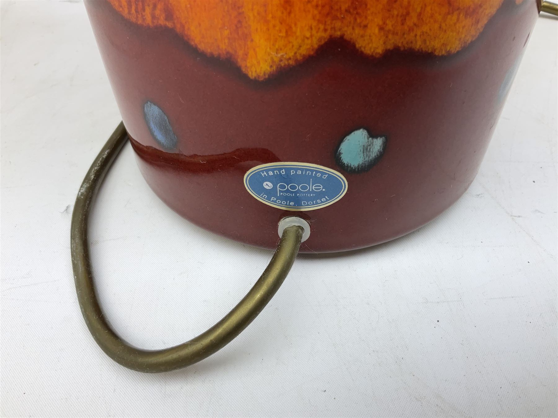 Poole Pottery table lamp in Volcano pattern of cylindrical form, with a cream lampshade, lamp H30cm