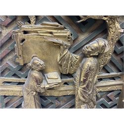 Two carved oriental wall hangings, the first example gilded depicting a temple and garden scene, the second figures in a garden, L49cm