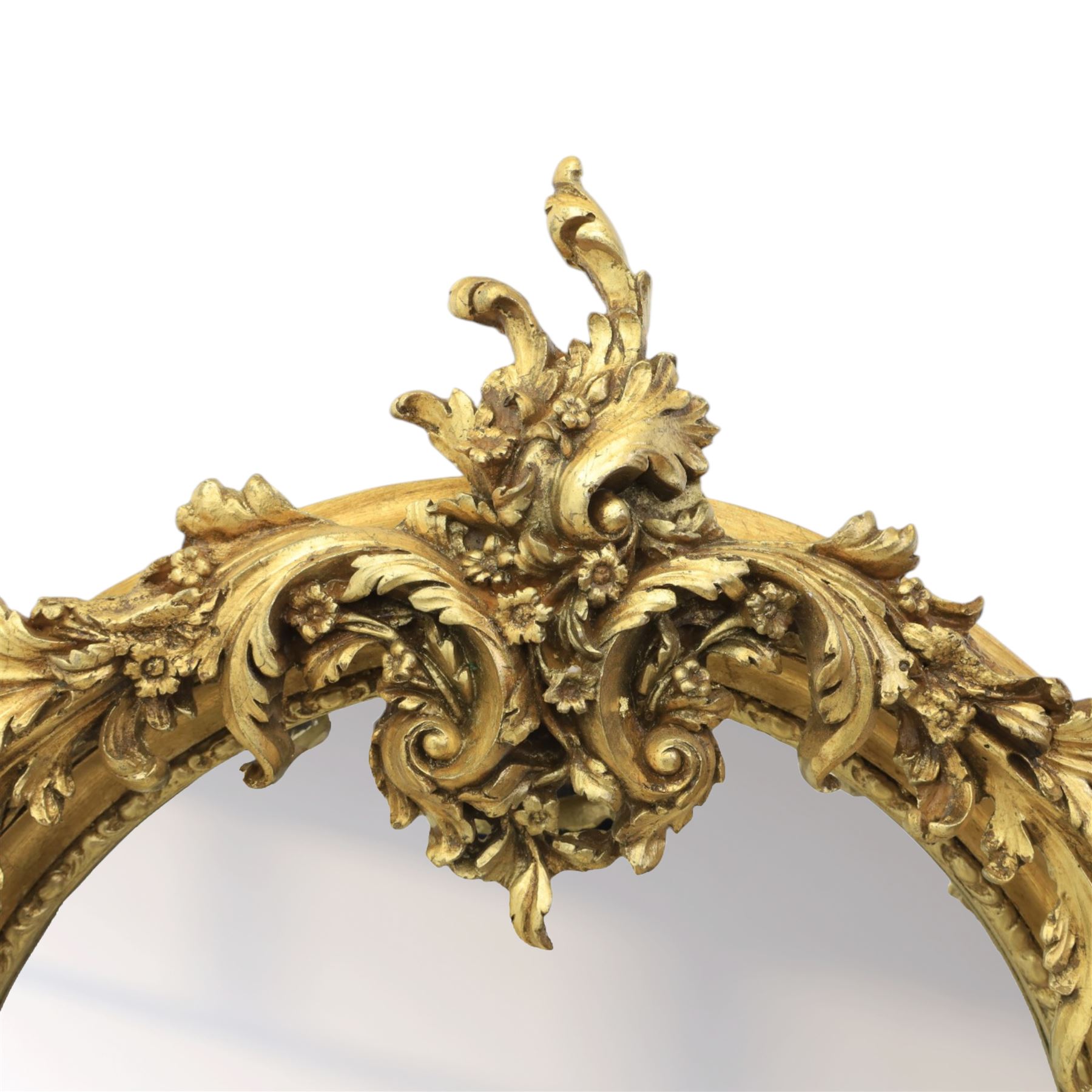Pair of Louis XV style giltwood overmantel mirrors, the arched rectangular frame surmounted by an elaborate pierced cresting of acanthus scrolls, rocailles and floral swags, the moulded frame with continuous foliate carving and beaded inner slip