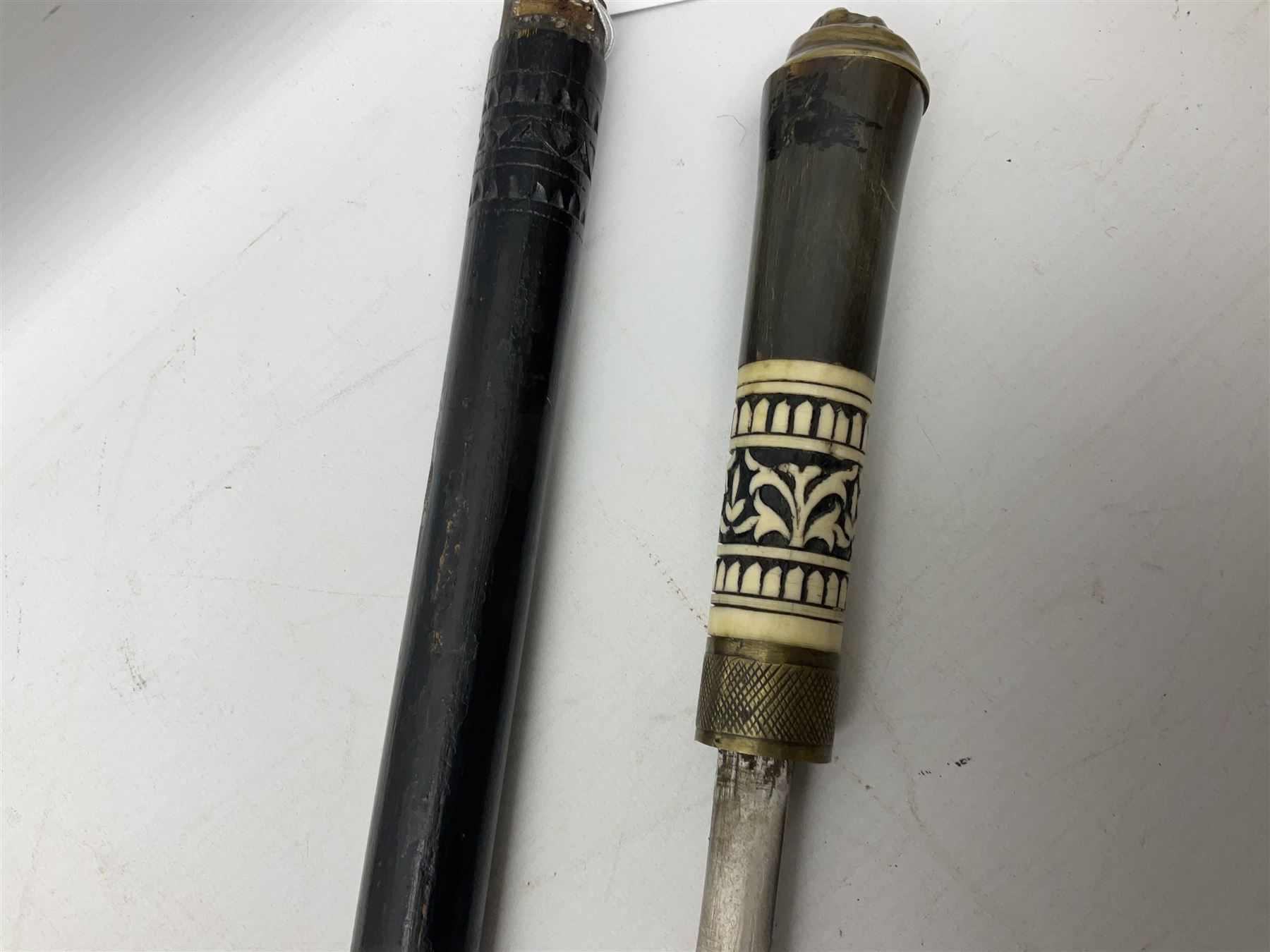 Early 20th century Indian ebonised sword stick, the 59.5cm blade with punched decoration and horn grip L94cm overall; and a reproduction Indian tulwar with scabbard (2)