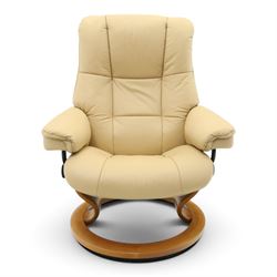 Ekornes Stressless - beech framed reclining swivel armchair with matching footstool, on U-shaped supports with circular bases, upholstered in beige leather