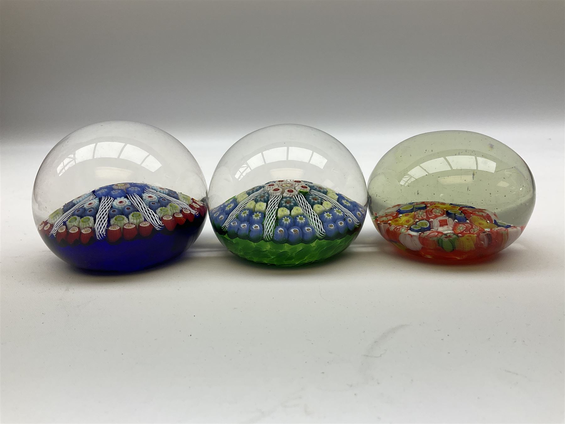 Five Millefiori glass paperweights, of differing designs, predominately by Strathearn