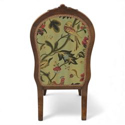 Small Victorian mahogany nursing chair, with carved top rail above a padded balloon back and shaped seat upholstered in light green fabric detailed with exotic birds and flowering vines, raised upon cabriole front legs and turned rear supports
