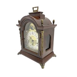 Hermle - 20th century 8-day chiming bracket clock, in a break arch mahogany case with carrying handle, brass dial with silvered chapter ring, chiming the hours and quarters on five gong rods, spring driven three train movement with a floating balance escapement. 