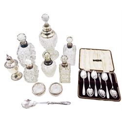 Group of silver, comprising set of six silver coffee spoons, in fitted case, six silver mounted cut glass scent bottles, pair of silver mounted cut glass open salts, and a silver handled preserve spoon, all hallmarked, together with an American silver pepper shaker on weighted foot, stamped sterling, tallest H20cm