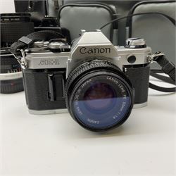 Canon AE1 camera, 'no. 4403757', fitted with Canon 'FD 50mm 1:1.8' lens, Hoya 'HMC Wide-Auto f24mm 1:2.8' lens and various other lenses and camera accessories, housed in a soft carry bag