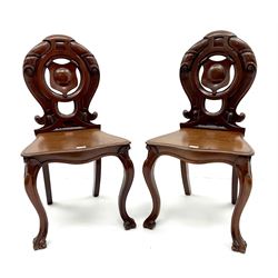 Pair of Victorian mahogany hall chairs, carved and pierced back, serpentine shaped seat, cabriole legs 