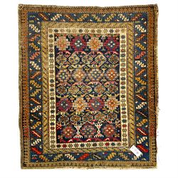 Small Caucasian rug or wall hanging, the indigo ground field decorated with geometric Gul motifs within multiple bands of geometric motifs