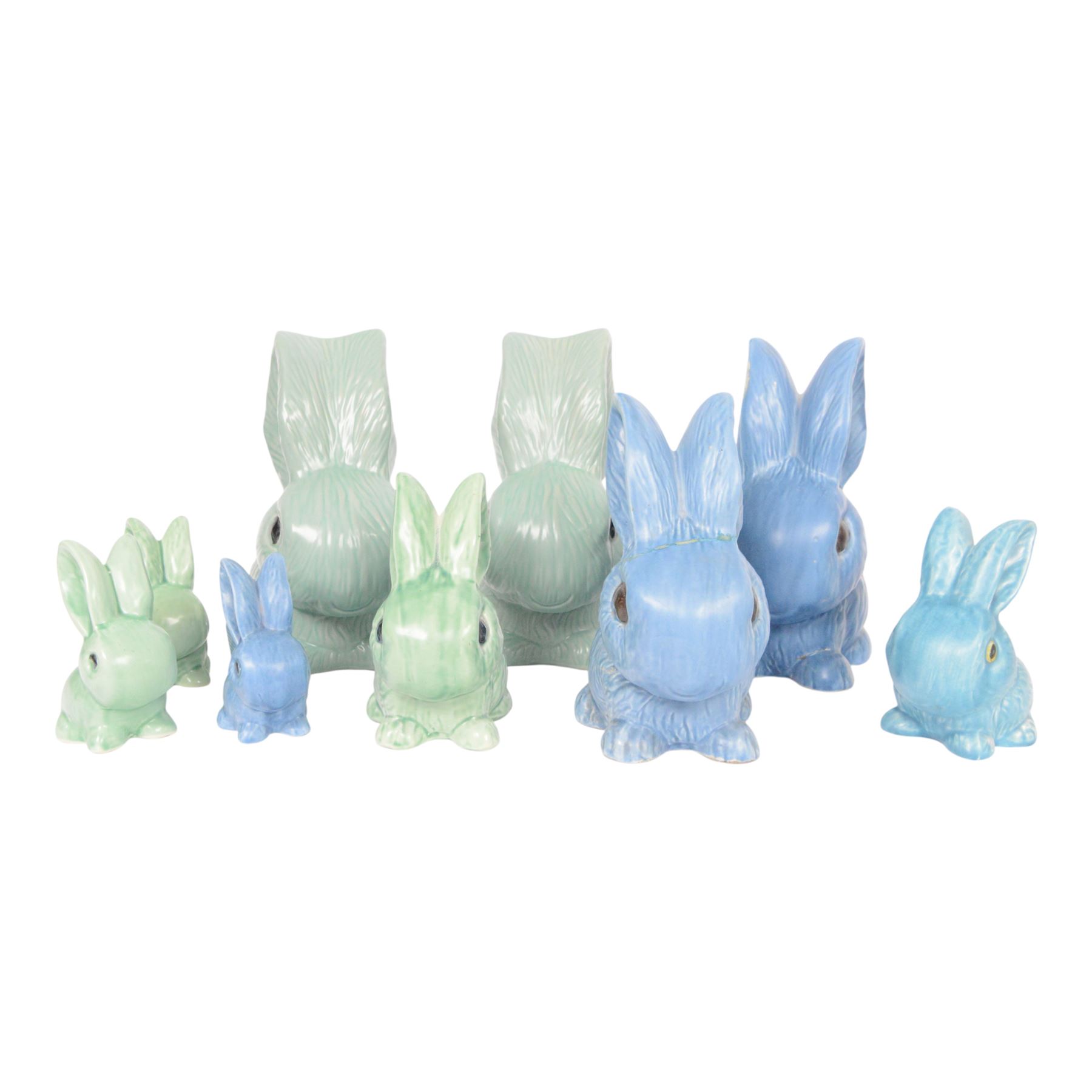 Nine Sylvac rabbits, including models 1028, 990, 1026 etc, in blue and green, largest H25cm  