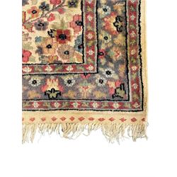 Persian design ivory ground rug, the busy field decorated with interlacing branches and flower head, three band border with repeating floral design 