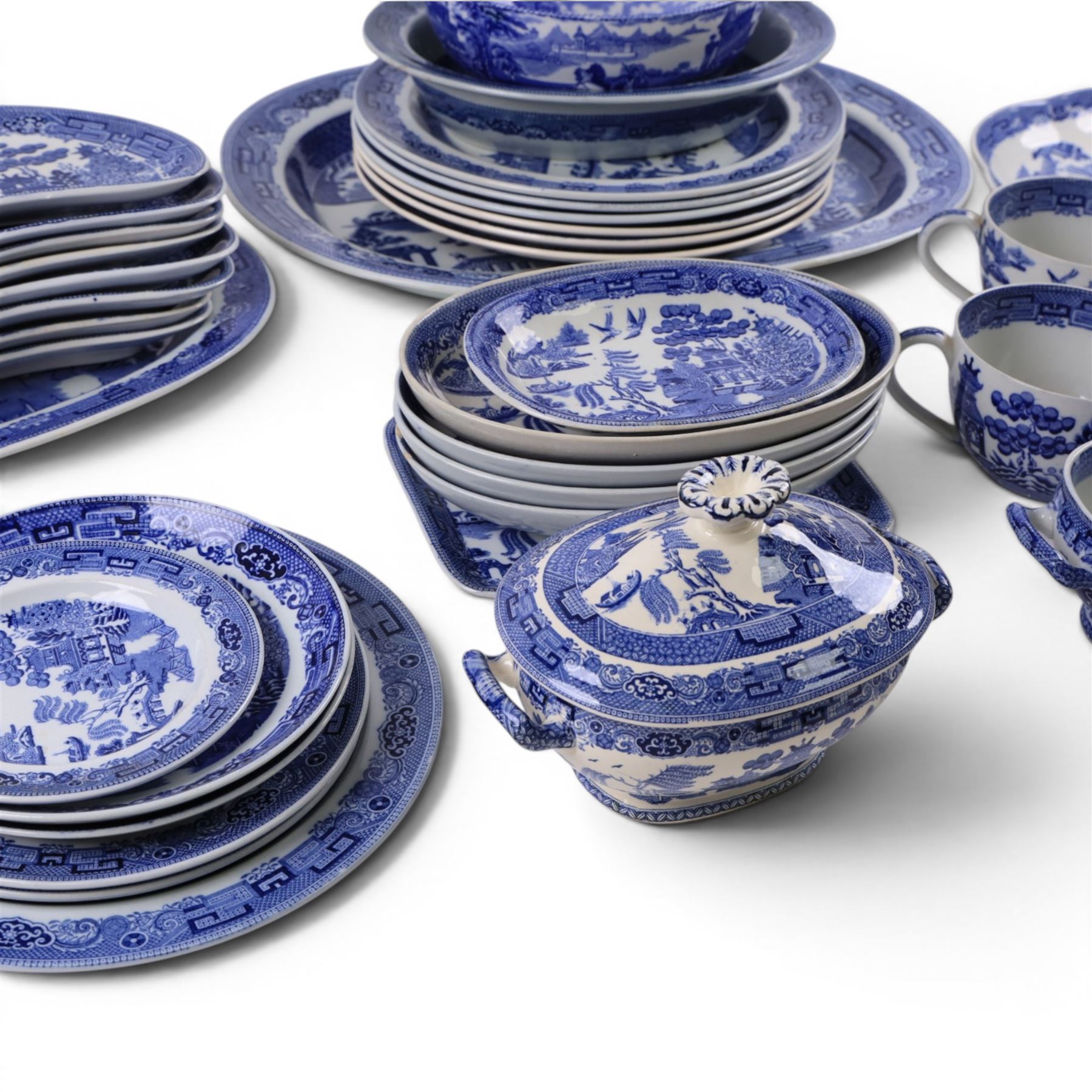 Collection of blue and white dinner wares, mainly Wedgwood Willow pattern, including serving platter, dinner plates etc   