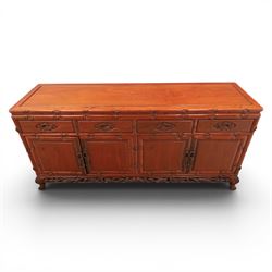 20th century Chinese ornately hardwood sideboard, rectangular top over four drawers above four cupboards, pierced carved apron, raised on cabriole legs 