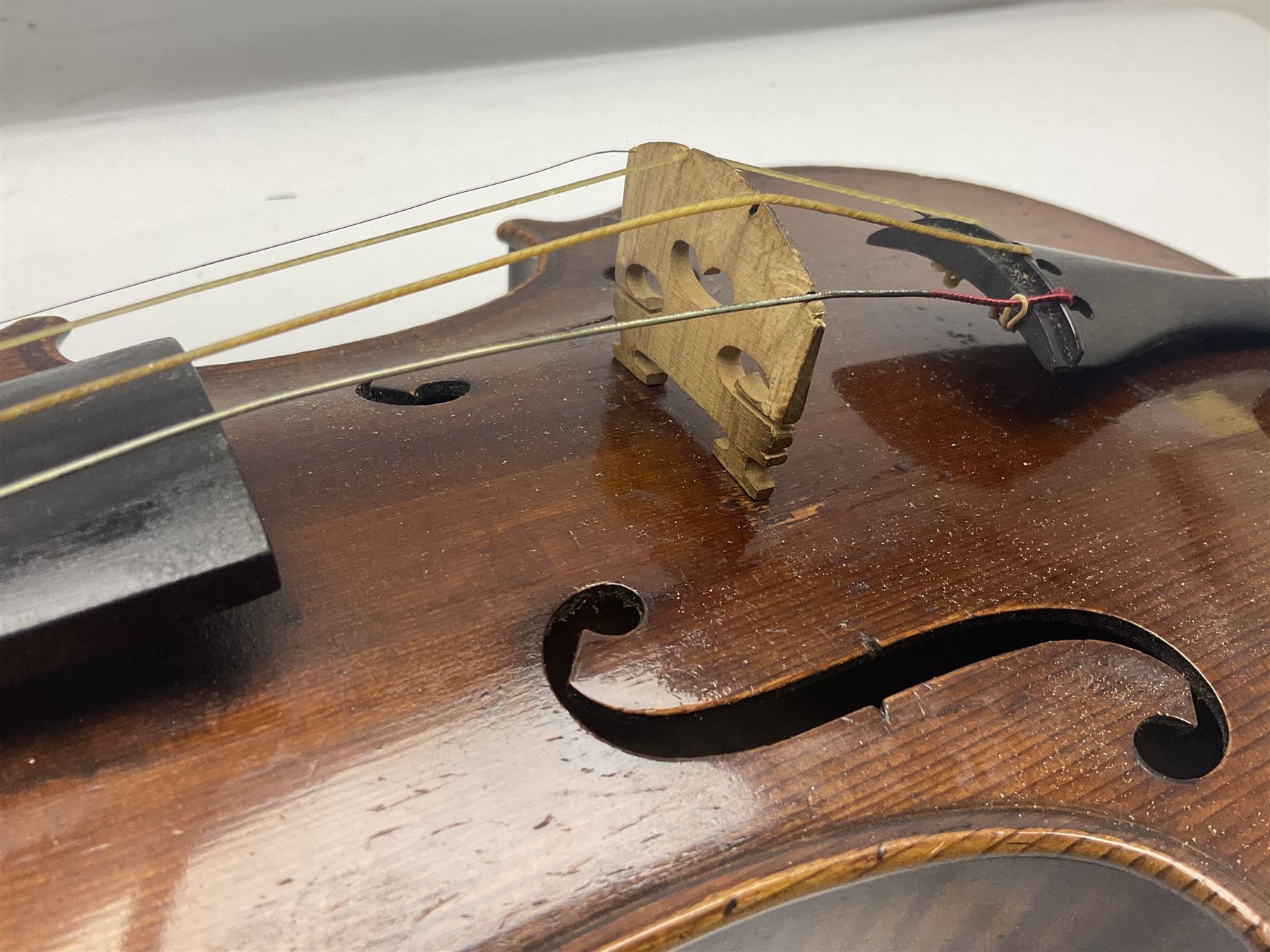 German trade violin c1900 with 35.5cm two-piece maple back and spruce top; bears label 'Made in Germany Apollo Class 6 No.2132' L59cm; in carrying case with two bows