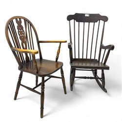 Early 20th century Windsor design rocking chair, shaped cresting rail over a spindle back, curved arms and plain seat, raised on turned supports with curved rockers; mahogany wheelback armchair raised on turned supports with H-stretcher 