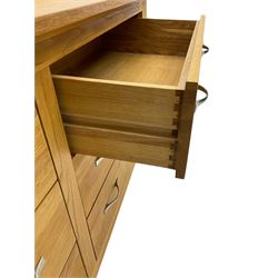 Contemporary wide oak straight-front chest, fitted with a bank of six drawers with chrome handles, on tapered feet