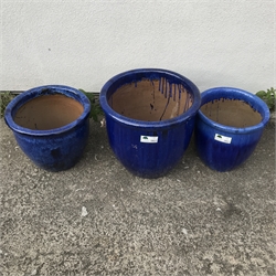 Three graduating blue glazed terracotta pots, H51cm (max)