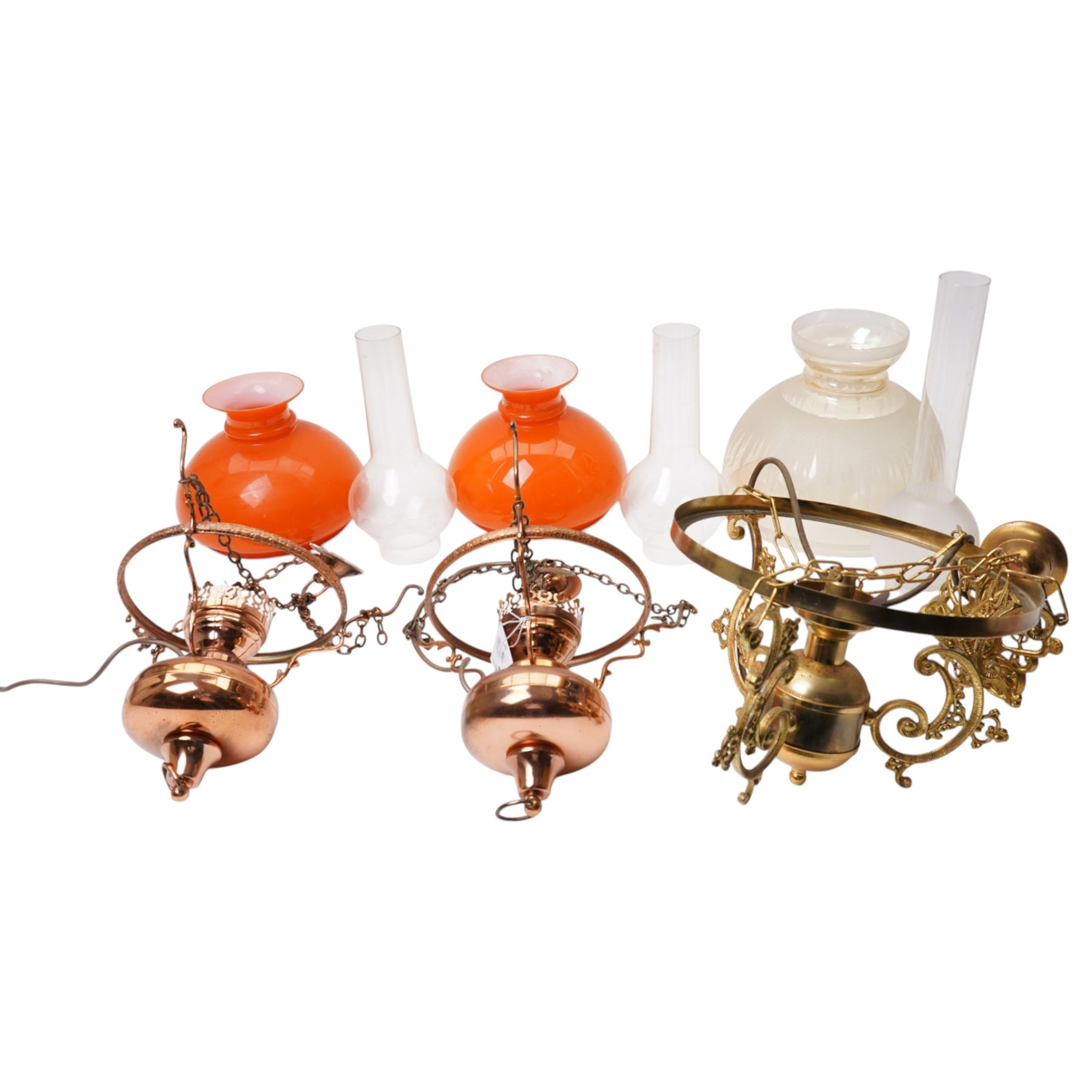 Pair of brass pendant light fittings with orange glass shades and another with partly frosted glass shade 
