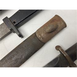 British No 7 MKI knife bayonet with 20cm single edged fullered clipped point blade;  blackened steel, large muzzle ring cross-guard; blackened swivelling pommel marked 'F5H'; red Tufnol composite grips; in blackened steel scabbard L33cm overall; British Pattern 1888 bayonet with scabbard; and German Ersatz bayonet with scabbard (3)