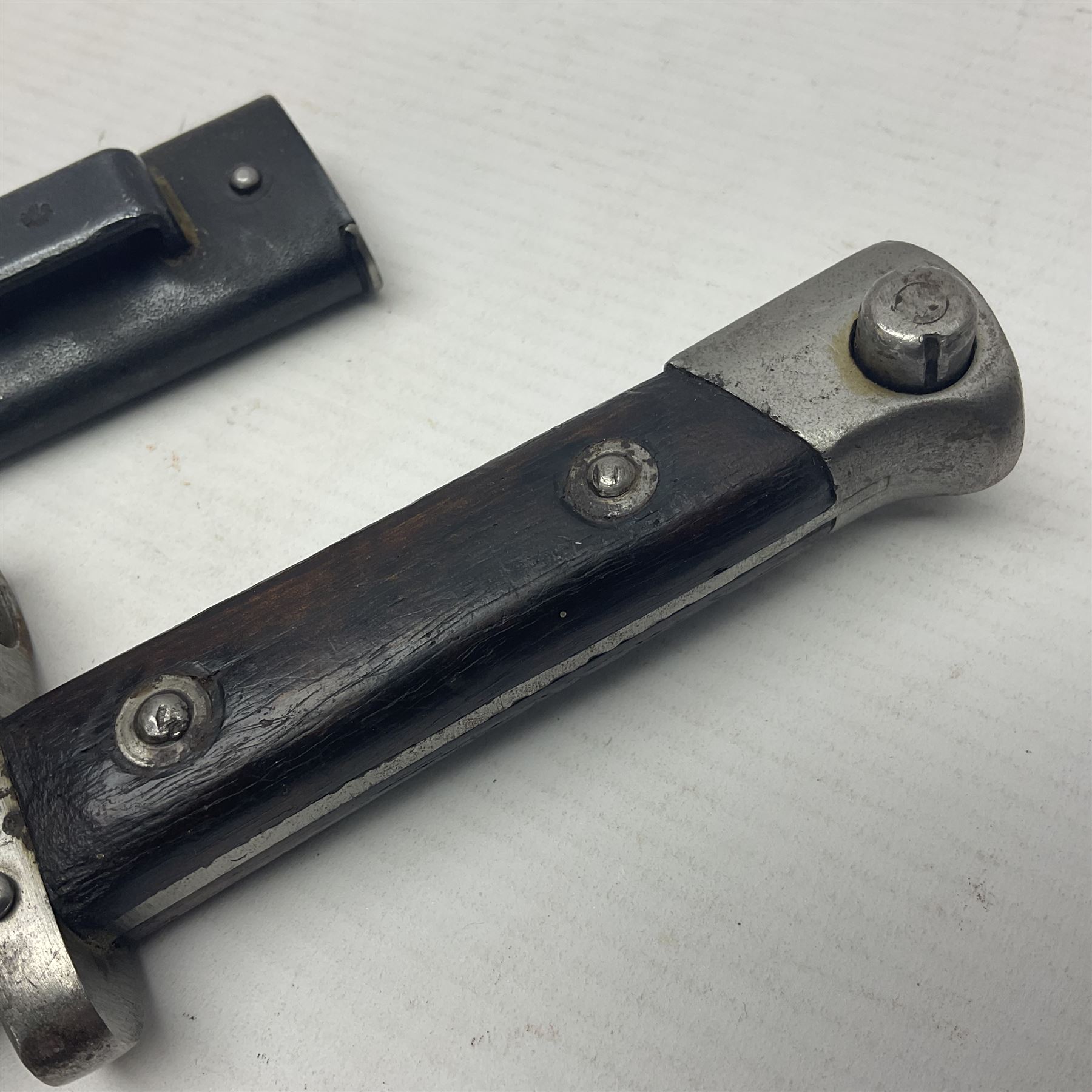 Austrian Model 1895 Carbine knife bayonet with 24.5cm fullered steel blade; various marks to the ricasso including F.G. GY.; cross-piece marked No.7843; in steel scabbard L37cm overall