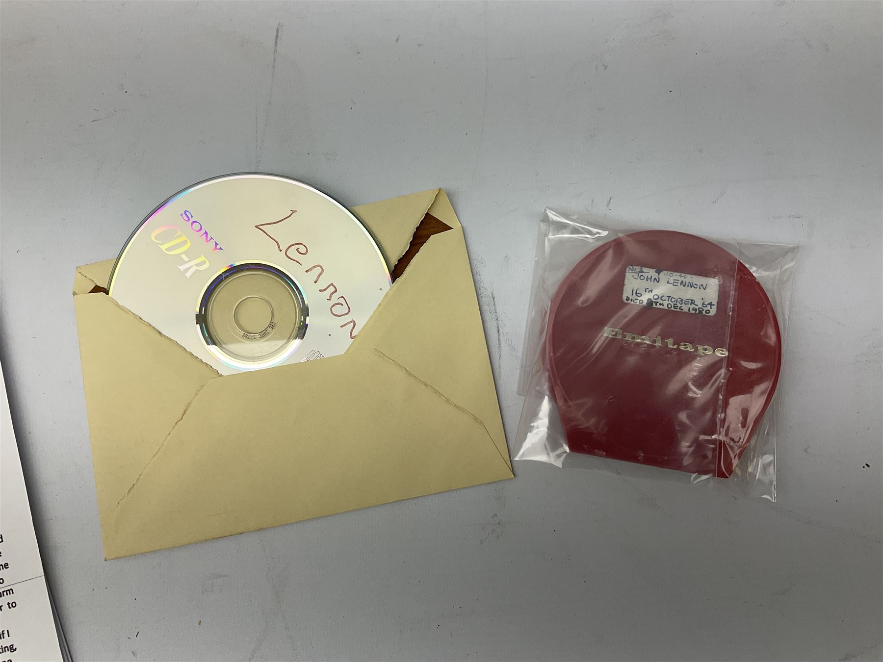 John Lennon interview recording conducted by John Hill student of Hull University on the 16th October 1964 at the A.B.C. Theatre Hull on behalf of the university newspaper 'Torchlight'. The interview lasts eight and a half minutes. It catches John in an upbeat breezy mood answering questions about the following topics: the song writing process ('sometimes you get an idea ....I dunno....my left leg.... and then write about that....'), recording (.... 'they just say - you're recording on such and such a date and they hope we turn up with some good songs written ....'), an alternative career path (.... 'I'd probably just have been a lay-about....'), failing at college (....'some other lads did my exams for me ....'), reading matter ( Clockwork Orange, Alice in Wonderland), his books of prose, tastes in music, the Blues, The Rolling Stones, being a Beatle vis-a-vis anonymity ('Whatever I'd be I'd choose to be rich .... who wants to walk down the street?').
The interview was recorded on 1/4 inch Emitape on a Fi-Cord Fidelity Recording machine. The reel-to-reel tape comes in its original Emitape plastic box and is accompanied by the Fi-Cord reel-to-reel machine on which the interview was originally recorded. Also included in this lot are a copy of the 'Torchlight' newspaper from 21st November 1964, two photographs of the interviewer with John Lennon (the interviewer is pictured to the left of John Lennon in the photograph in which John is signing a sketch) and one photograph of Paul McCartney with another reporter, the largest measures 12 x 16.5cm and a transcript of the interview. The recording is also accompanied by the original Fi-Cord tape recorder with microphone, four original 2v batteries and battery charger. The tape recorder has been adapted to take 3xAA batteries and the 2v battery charger is fitted with a standard UK 3-pin AC plug. The interview was recorded in the press room prior to the Beatles concert at the A.B.C. Theatre and is sold with copyright.