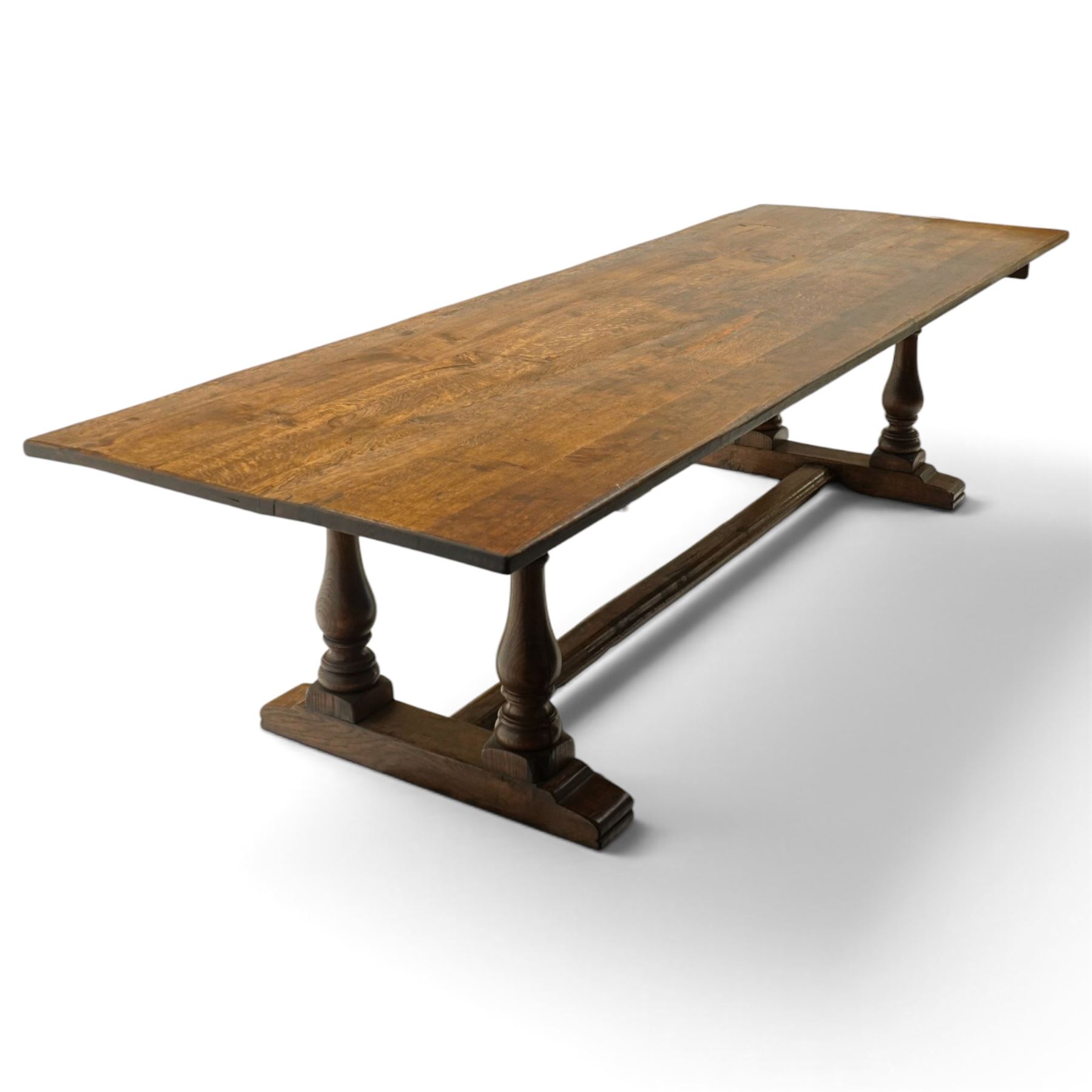 Large 17th century design oak 10ft refectory dining table, the rectangular top raised on twin double-vasiform pedestal end supports on sledge feet, united by chamfered stretcher