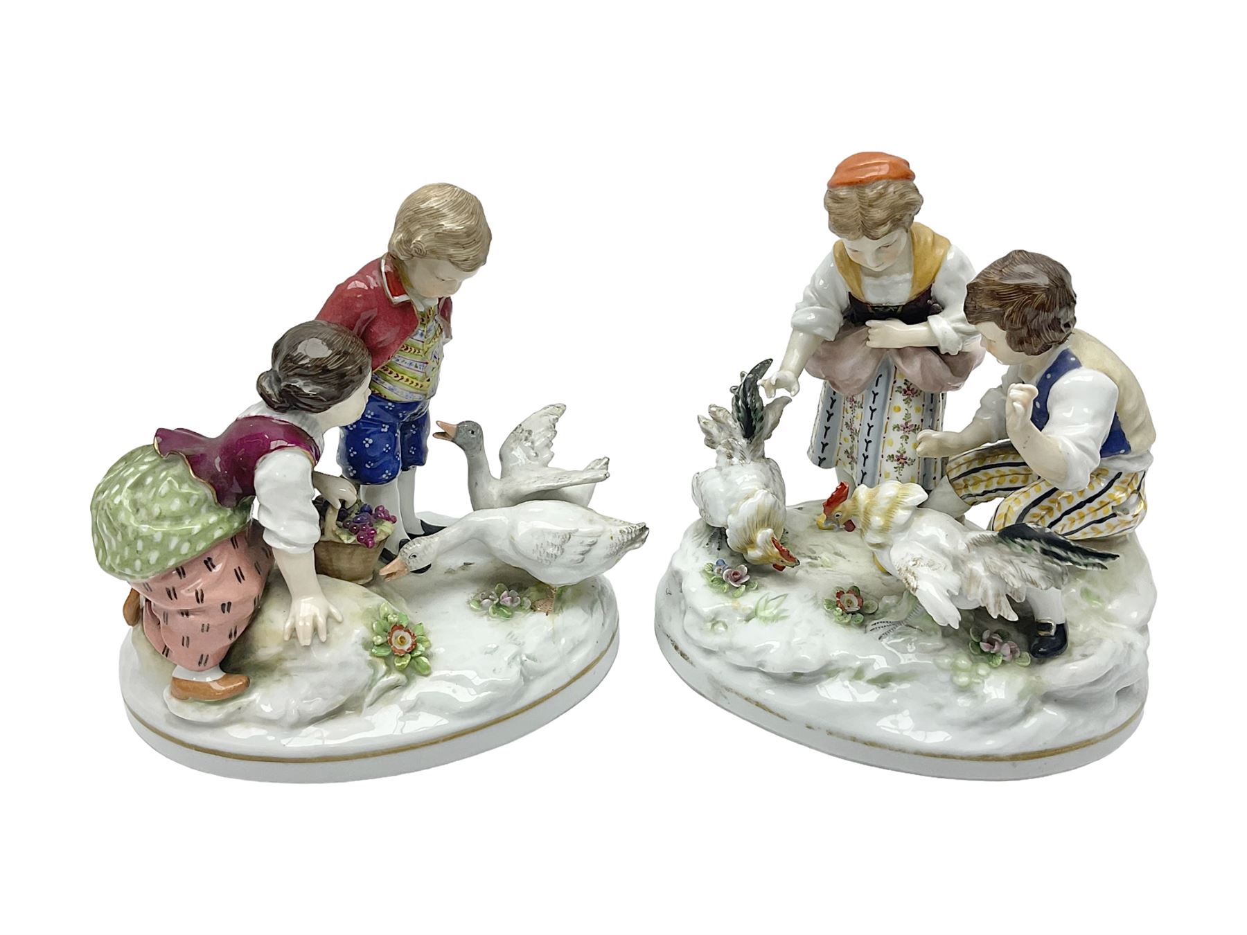 Two 19th century german figures, each modelled as children feeding birds, H19cm 