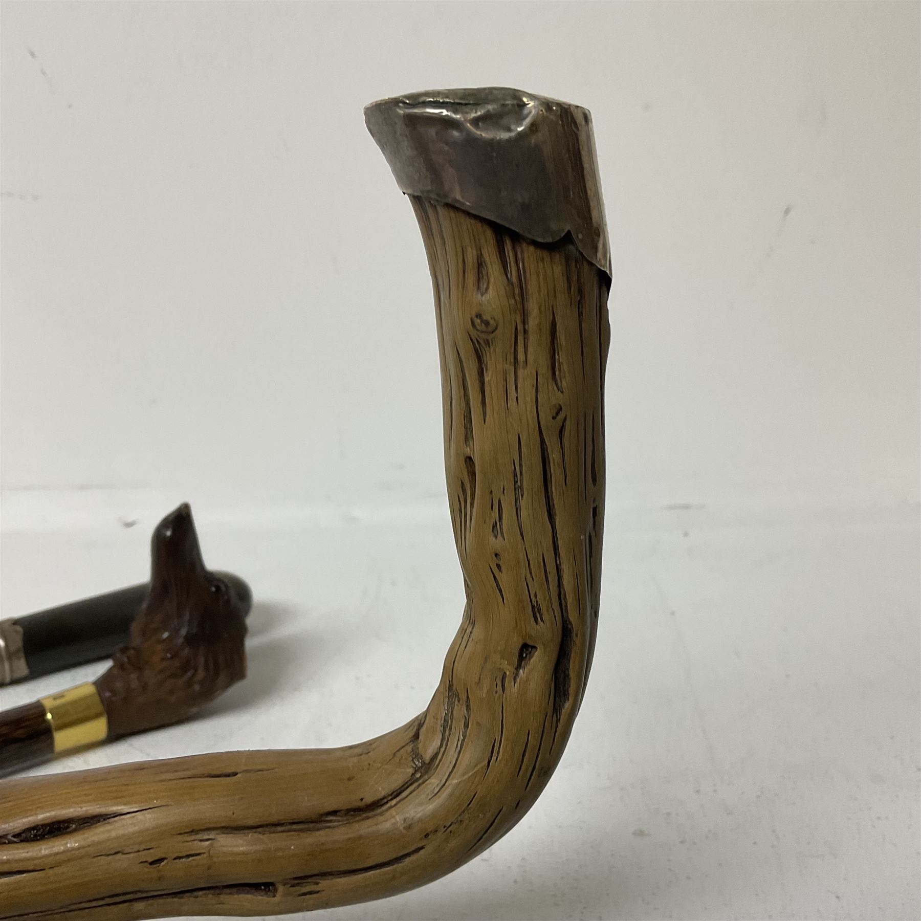 19th century painted bamboo walking cane, the handle carved as a fox with glass eyes, with gilt metal stamped LB, together with an ebonised wooden walking stick, with horn pommel and hallmarked silver collar and a curved wooden walking stick, with monogrammed white metal cap, tallest L90cm