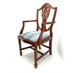 Yew wood twin pedestal extending dining table, shaped supports and brass castors (W216cm, D100cm, H77cm) and six (4+2) chairs, shaped back and upholstered in patterned fabric raised on fluted supports (W52cm)