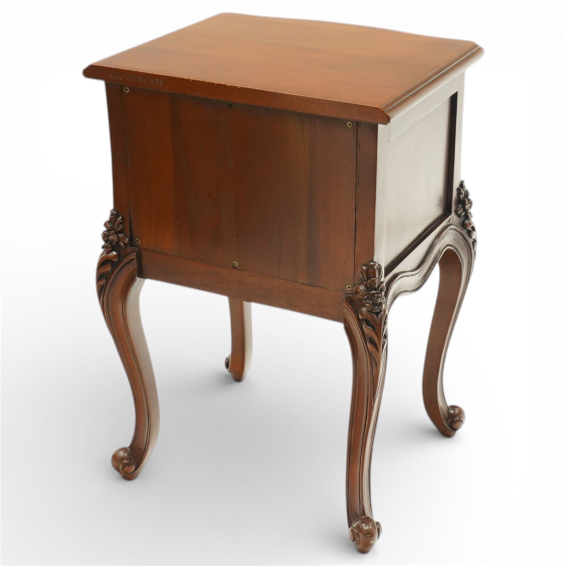 Pair of French Rococo design bedside chests, with serpentine fronts, two drawers, brass handles and carved floral decoration, raised on cabriole legs with scroll feet