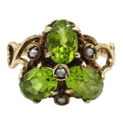 9ct gold three stone oval peridot and seed pearl ring, with open scroll design shoulders, London 1976