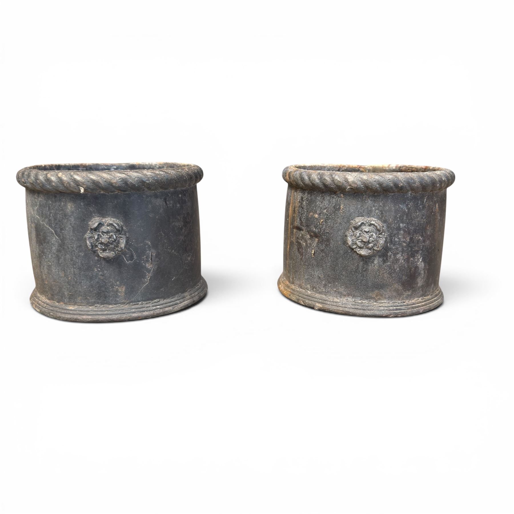 Pair of 19th century lead garden planters of cylindrical form, the rolled rope twist rims over a plain body decorated with applied flowerhead roundels, in antique weathered finish