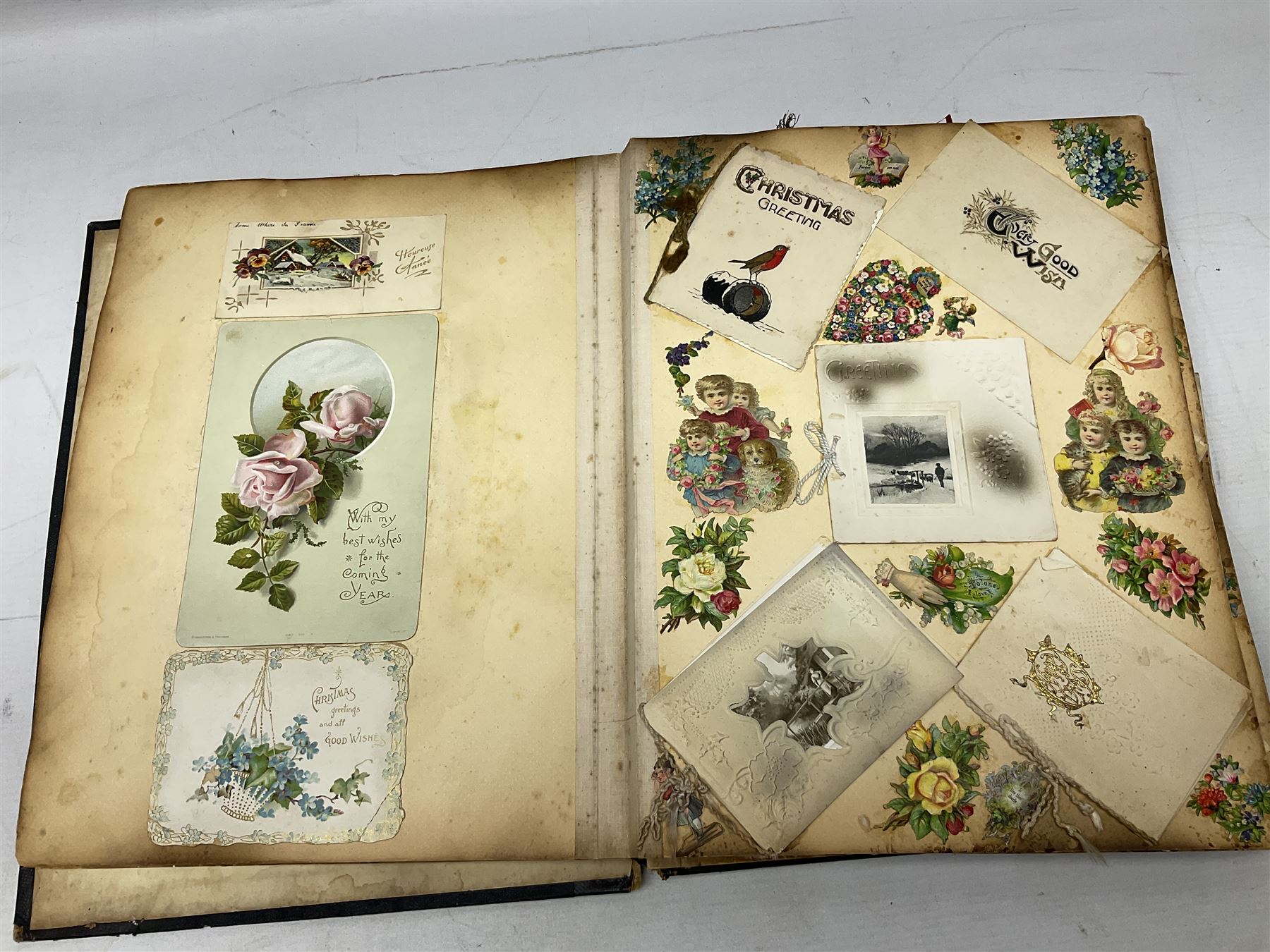 Victorian scrapbook of various fixed decoupage to include, greeting cards, portraiture, flowers, animals etc,