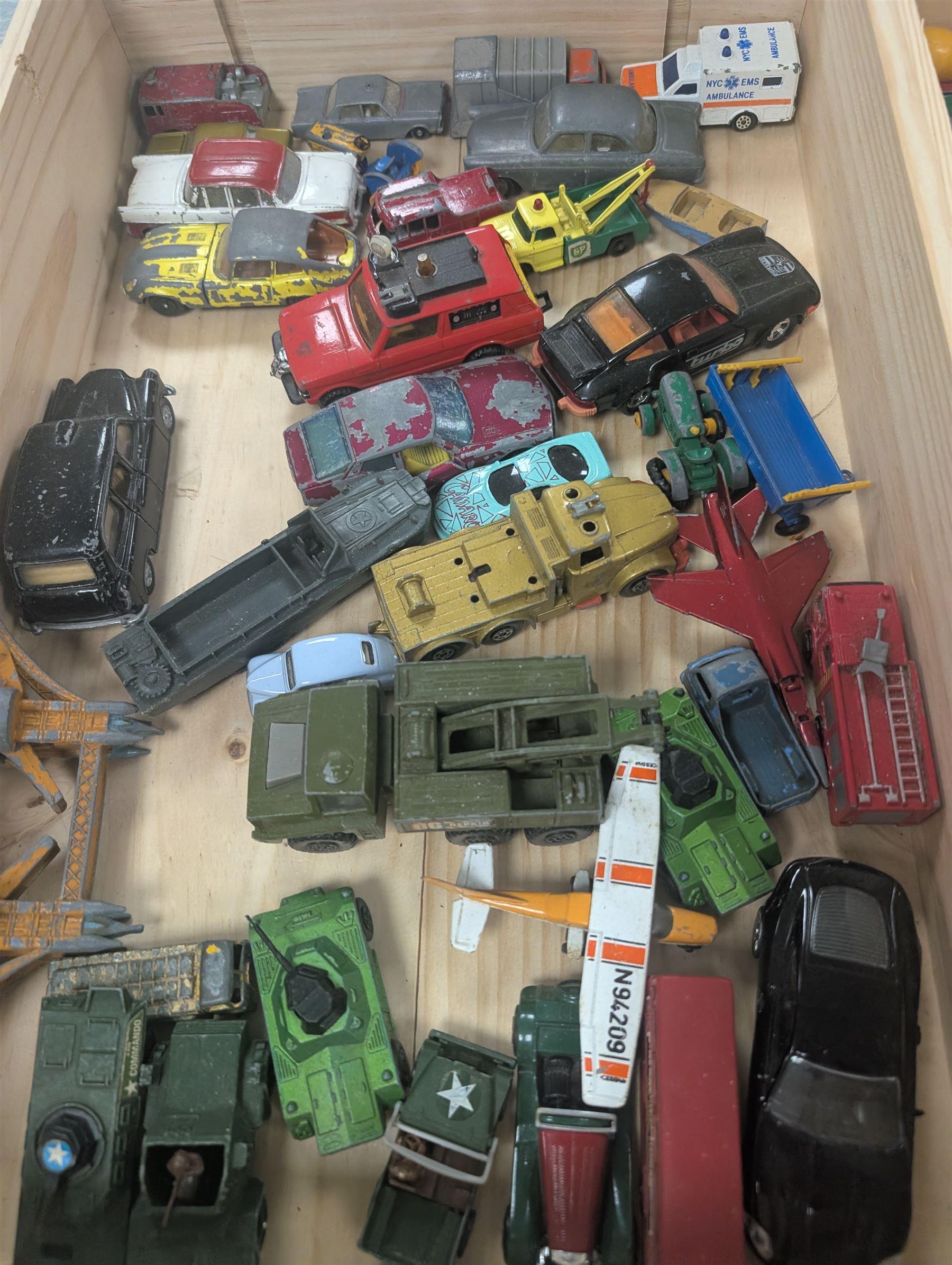 Collection of Matchbox Lesney and similar diecast model vehicles, including buses, lorries, cars, cranes, etc, all loose and playworn, in two wooden wine crates